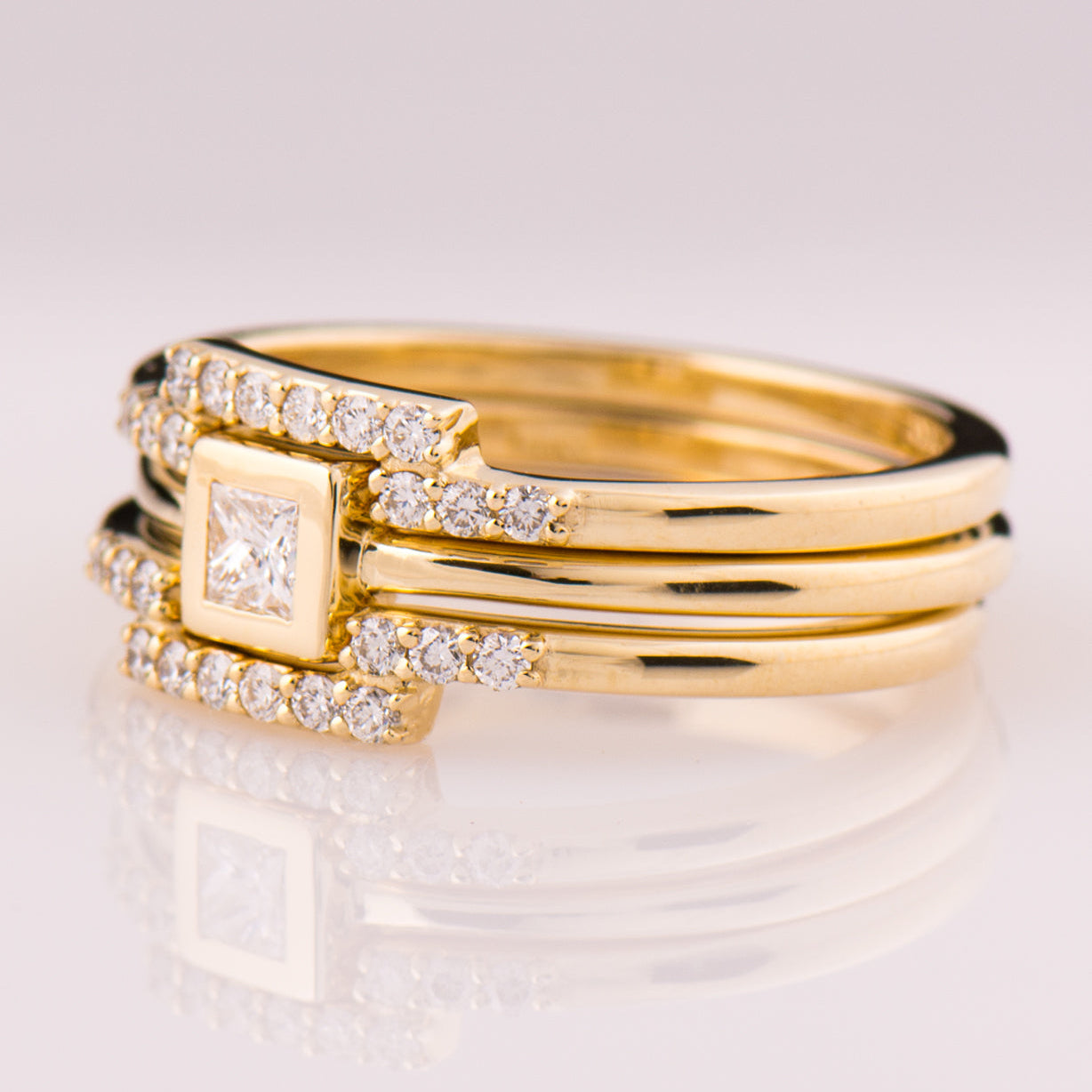 Gold rings with diamond accents on a white background