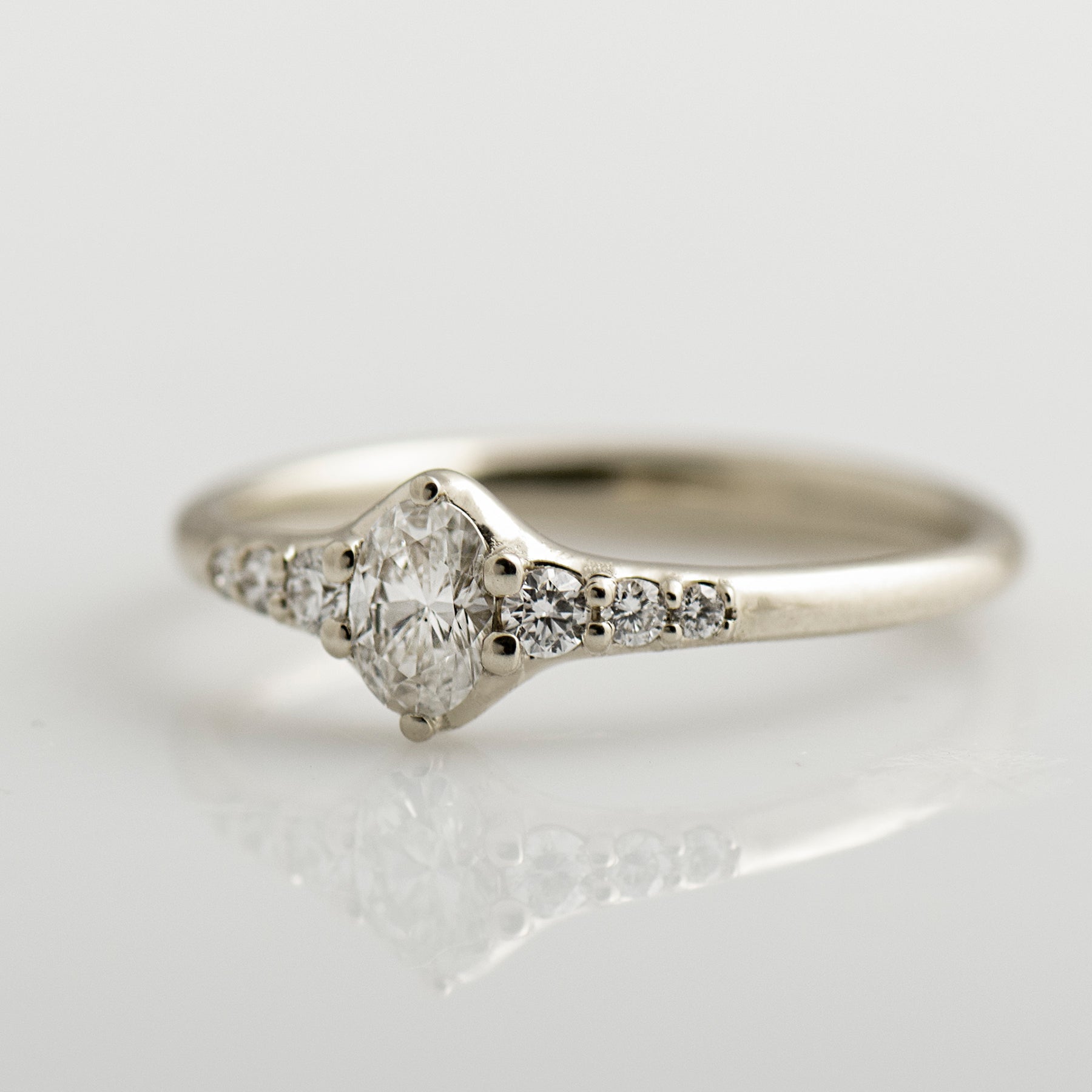 Tapered tiny oval diamond ring